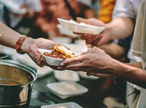 The help of volunteers helps to donate free food to the starving people.